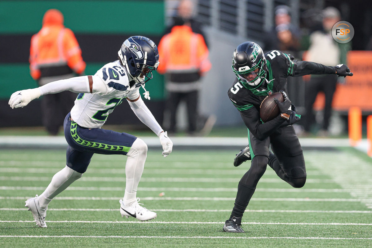 Dec 1, 2024; East Rutherford, New Jersey, USA; New York Jets wide receiver Garrett Wilson (5) fights for yards as Seattle Seahawks cornerback Josh Jobe (29) defends during the second half at MetLife Stadium. Credit: Vincent Carchietta-Imagn Images