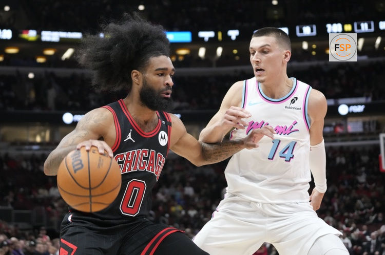 Apr 9, 2025; Chicago, Illinois, USA; Miami Heat forward Andrew Wiggins (22) defends Chicago Bulls guard Coby White (0) during the first quarter at United Center. Credit: David Banks-Imagn Images