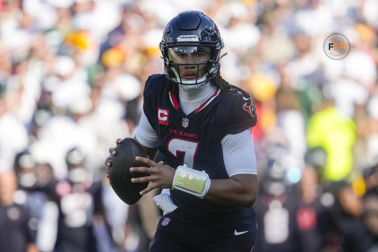 Oct 20, 2024; Green Bay, Wisconsin, USA;  Houston Texans quarterback C.J. Stroud (7) looks to throw a pass during the second quarter against the Green Bay Packers at Lambeau Field. Credit: Jeff Hanisch-Imagn Images