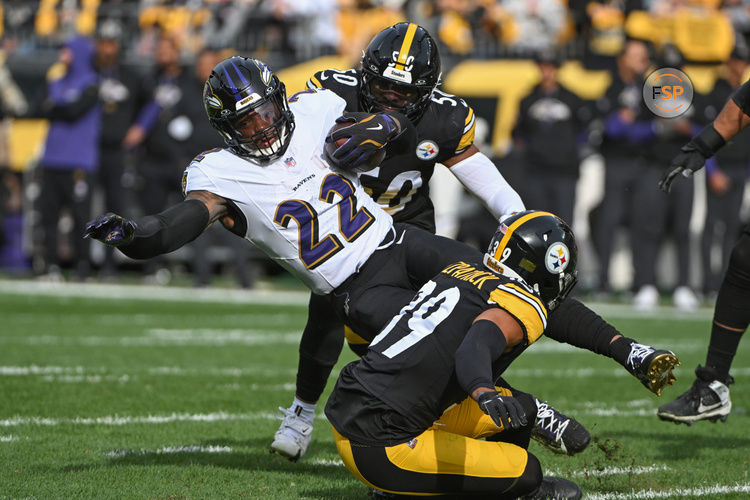 Nov 17, 2024; Pittsburgh, Pennsylvania, USA; Pittsburgh Steelers defenders Elandon Roberts (50) and Minkah Fitzpatrick (39) tackle Baltimore Ravens running back Derrick Henry (22) during the first quarter at Acrisure Stadium. Credit: Barry Reeger-Imagn Images