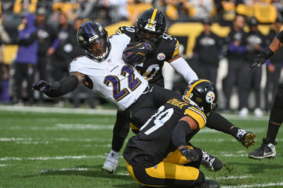 Nov 17, 2024; Pittsburgh, Pennsylvania, USA; Pittsburgh Steelers defenders Elandon Roberts (50) and Minkah Fitzpatrick (39) tackle Baltimore Ravens running back Derrick Henry (22) during the first quarter at Acrisure Stadium. Mandatory Credit: Barry Reeger-Imagn Images