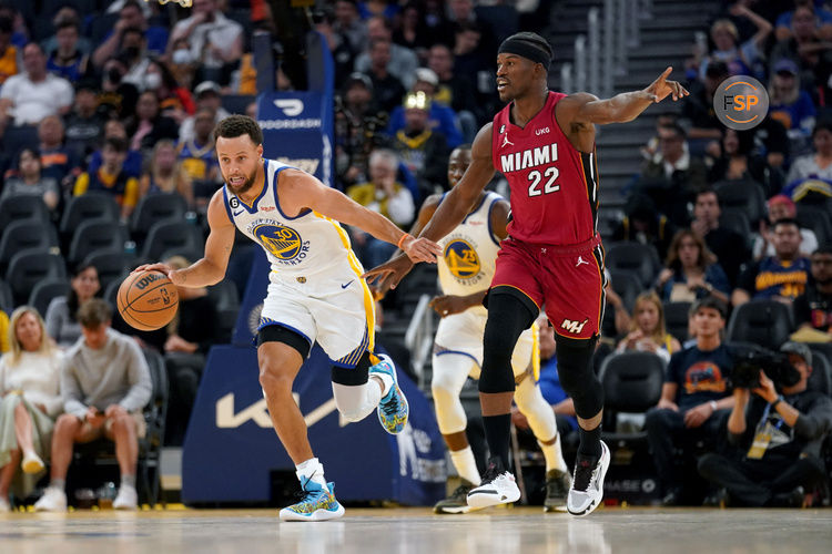 Oct 27, 2022; San Francisco, California, USA; Golden State Warriors guard Stephen Curry (30) dribbles past Miami Heat forward Jimmy Butler (22) in the third quarter at the Chase Center. Credit: Cary Edmondson-USA TODAY Sports