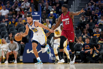 Oct 27, 2022; San Francisco, California, USA; Golden State Warriors guard Stephen Curry (30) dribbles past Miami Heat forward Jimmy Butler (22) in the third quarter at the Chase Center. Mandatory Credit: Cary Edmondson-USA TODAY Sports