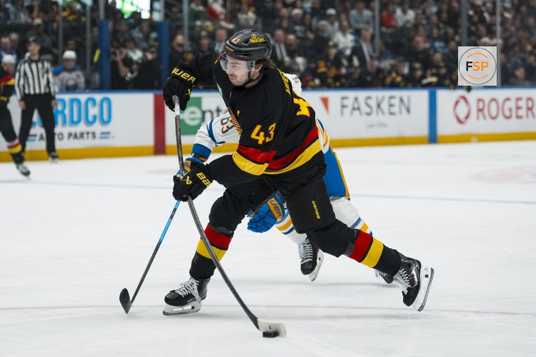 Dec 11, 2025; Vancouver, British Columbia, CAN; Vancouver Canucks defenseman Quinn Hughes (43) shoots against the Buffalo Sabres in the first period at Rogers Arena. Credit: Bob Frid-Imagn Images