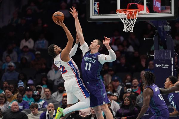 Jan 26, 2026; Charlotte, North Carolina, USA; Charlotte Hornets center Ryan Kalkbrenner (11) goes up for a block on the shot by Philadelphia 76ers guard/forward Trendon Watford (12) during the second half at Spectrum Center. Mandatory Credit: Jim Dedmon-Imagn Images