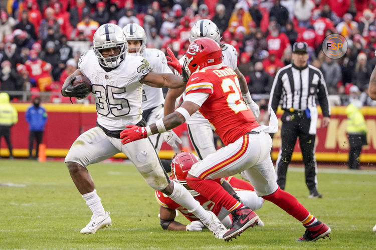 Dec 25, 2023; Kansas City, Missouri, USA; Las Vegas Raiders running back Zamir White (35) runs the ball as Kansas City Chiefs safety Mike Edwards (21) attempts the tackle during the second half at GEHA Field at Arrowhead Stadium. Credit: Denny Medley-USA TODAY Sports