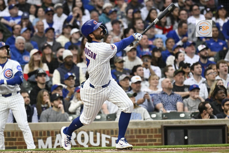 Apr 22, 2025; Chicago, Illinois, USA;  Chicago Cubs shortstop Dansby Swanson (7) hits an RBI triple during the first inning against the Los Angeles Dodgers at Wrigley Field. Credit: Matt Marton-Imagn Images