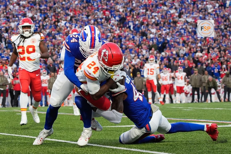 Nov 2, 2025; Orchard Park, New York, USA; Kansas City Chiefs running back Brashard Smith (24) is brought down by Buffalo Bills safety Cole Bishop (24) and cornerback Christian Benford (47) in the first quarter at Highmark Stadium. Credit: Gregory Fisher-Imagn Images