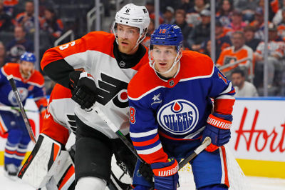 Oct 15, 2024; Edmonton, Alberta, CAN; Edmonton Oilers forward Zach Hyman (18) and Philadelphia Flyers defensemen Travis Sanheim (6) battle for position  during the third period at Rogers Place. Mandatory Credit: Perry Nelson-Imagn Images