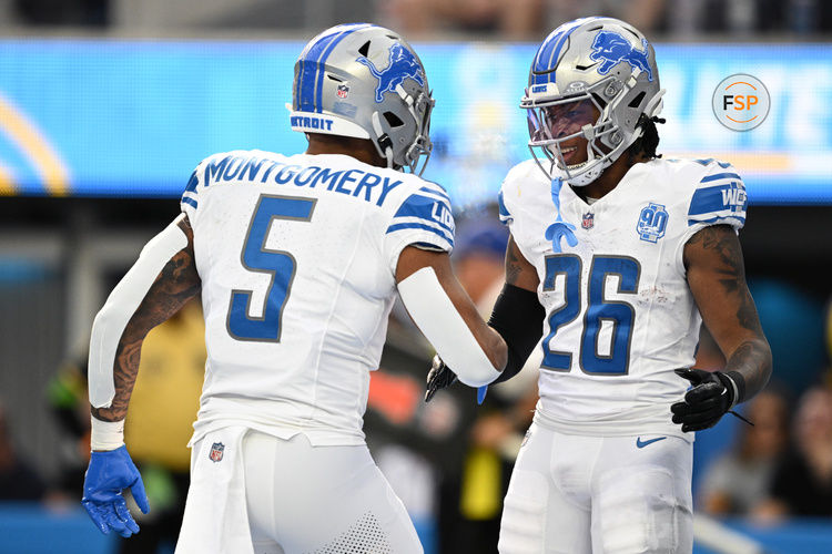 Nov 12, 2023; Inglewood, California, USA; Detroit Lions running back Jahmyr Gibbs (26) celebrates with running back David Montgomery (5) after scoring a touchdown  against the Los Angeles Chargers during the first half at SoFi Stadium. Credit: Orlando Ramirez-USA TODAY Sports