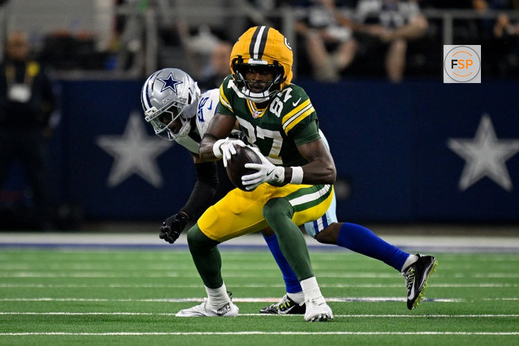 Sep 28, 2025; Arlington, Texas, USA; Green Bay Packers wide receiver Romeo Doubs (87) catches a pass over Dallas Cowboys cornerback DaRon Bland (26) during the game between the Dallas Cowboys and the Green Bay Packers at AT&T Stadium. Credit: Jerome Miron-Imagn Images
