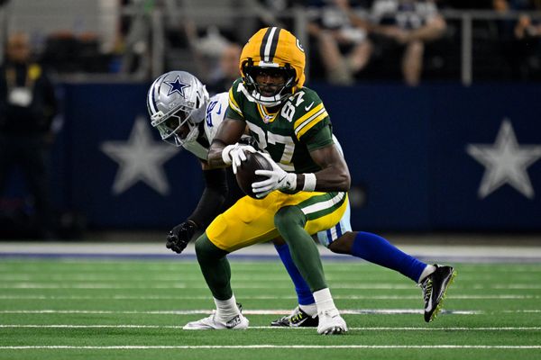 Sep 28, 2025; Arlington, Texas, USA; Green Bay Packers wide receiver Romeo Doubs (87) catches a pass over Dallas Cowboys cornerback DaRon Bland (26) during the game between the Dallas Cowboys and the Green Bay Packers at AT&T Stadium. Mandatory Credit: Jerome Miron-Imagn Images
