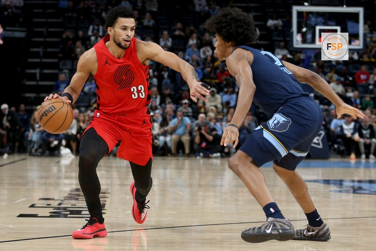 Dec 7, 2025; Memphis, Tennessee, USA; Portland Trail Blazers forward Toumani Camara (33) drives to the basket as Memphis Grizzlies forward Jaylen Wells (0) defends during the first quarter at FedExForum. Credit: Petre Thomas-Imagn Images