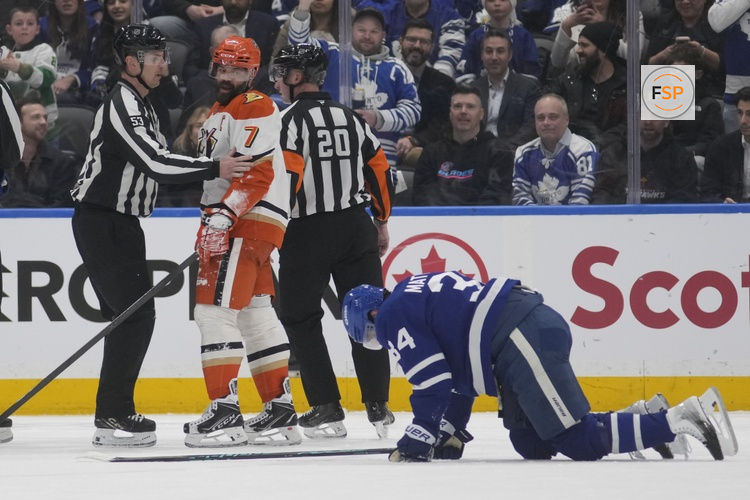 Mar 12, 2026; Toronto, Ontario, CAN; Anaheim Ducks defenseman Radko Gudas (7) looks at an injured Toronto Maple Leafs forward Auston Matthews (34) after he delivered a knee on knee hit during the second period at Scotiabank Arena. Credit: John E. Sokolowski-Imagn Images