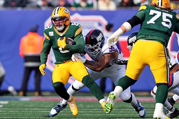 Nov 16, 2025; East Rutherford, New Jersey, USA; Green Bay Packers running back Josh Jacobs (8) runs the ball against New York Giants defensive tackle Roy Robertson-Harris (95) during the first quarter at MetLife Stadium. Mandatory Credit: Vincent Carchietta-Imagn Images