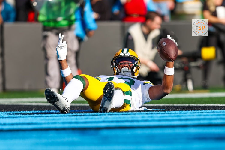 CHARLOTTE, NC - DECEMBER 24: Dontayvion Wicks #13 of the Green Bay Packers celebrates a touchdown during an NFL game against the Carolina Panthers at Bank of America Stadium on December 24, 2023 in Charlotte, NC. (Photo by David Jensen/Icon Sportswire)