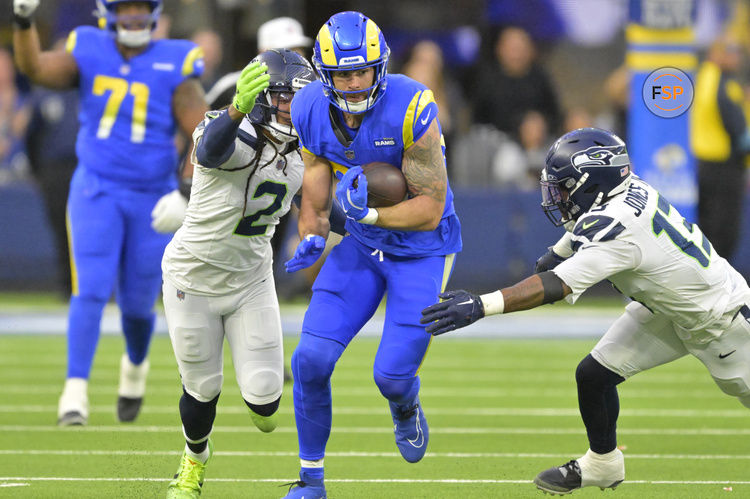 Jan 5, 2025; Inglewood, California, USA; Los Angeles Rams tight end Tyler Higbee (89) runs for a first down before he is stopped by Seattle Seahawks safety Rayshawn Jenkins (2) and linebacker Ernest Jones IV (13) in the second half at SoFi Stadium. Credit: Jayne Kamin-Oncea-Imagn Images