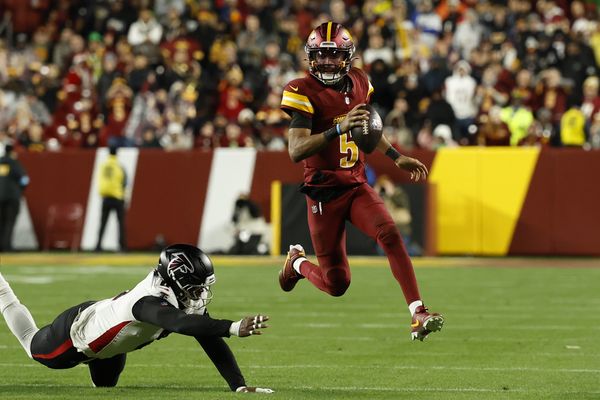 Dec 29, 2024; Landover, Maryland, USA; Washington Commanders quarterback Jayden Daniels (5) runs with the ball as Atlanta Falcons tight end Kyle Pitts (8) attempts a tackle during the third quarter at Northwest Stadium. Mandatory Credit: Geoff Burke-Imagn Images