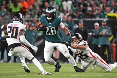 Sep 16, 2024; Philadelphia, Pennsylvania, USA; Philadelphia Eagles running back Saquon Barkley (26) tries to get way from Atlanta Falcons cornerback Dee Alford (20) and linebacker Kaden Elliss (55) at Lincoln Financial Field. Mandatory Credit: Eric Hartline-Imagn Images