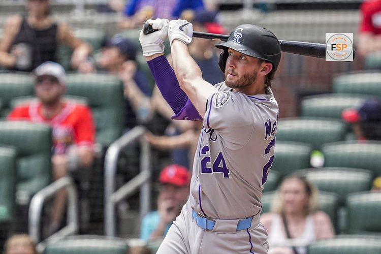 Jun 15, 2025; Cumberland, Georgia, USA; Colorado Rockies third baseman Ryan McMahon (24) hits a home run against the Atlanta Braves during the seventh inning at Truist Park. Credit: Dale Zanine-Imagn Images
