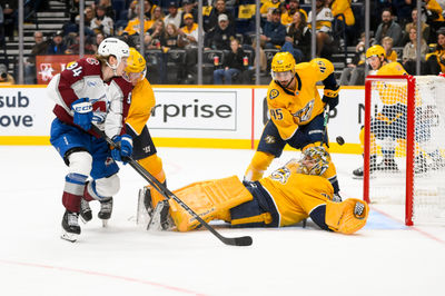 Nov 2, 2024; Nashville, Tennessee, USA;  Nashville Predators goaltender Juuse Saros (74) and center Gustav Nyquist (14) blocks the shot of Colorado Avalanche left wing Joel Kiviranta (94) during the second period at Bridgestone Arena. Mandatory Credit: Steve Roberts-Imagn Images