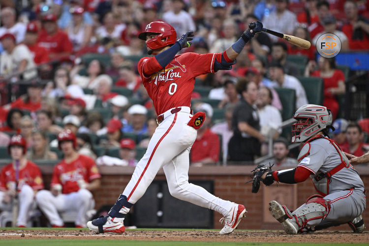 Jun 20, 2025; St. Louis, Missouri, USA; St. Louis Cardinals shortstop Masyn Winn (0) hits an RBI single against the Cincinnati Reds in the seventh inning at Busch Stadium. Credit: Joe Puetz-Imagn Images