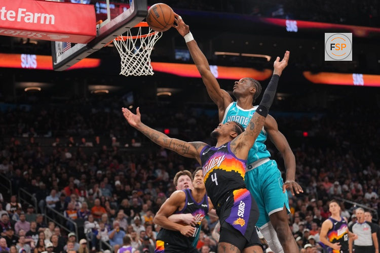 Mar 8, 2026; Phoenix, Arizona, USA; Charlotte Hornets forward Moussa Diabate (14) blocks a layup attempt by Phoenix Suns guard Jalen Green (4) during the second half at Mortgage Matchup Center. Credit: Joe Camporeale-Imagn Images
