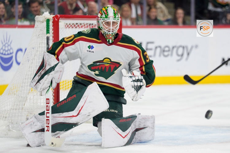 Dec 21, 2025; Saint Paul, Minnesota, USA; Minnesota Wild goaltender Jesper Wallstedt (30) watches a shot from the Colorado Avalanche in the second period at Grand Casino Arena. Credit: Matt Blewett-Imagn Images
