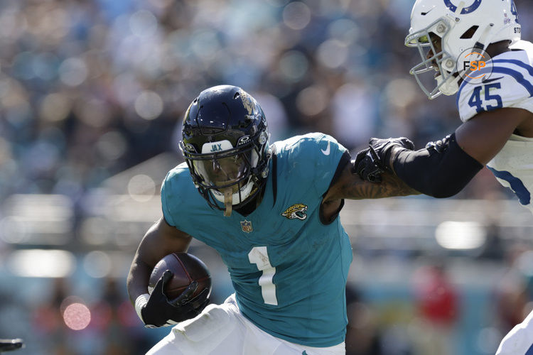 JACKSONVILLE, FL - OCTOBER 15: Jacksonville Jaguars running back Travis Etienne Jr. (1) runs with the ball during the game between the against the Indianapolis Colts and theJacksonville Jaguars on October 15, 2023 at Ever bank Stadium in Jacksonville, Florida. (Photo by David Rosenblum/Icon Sportswire)