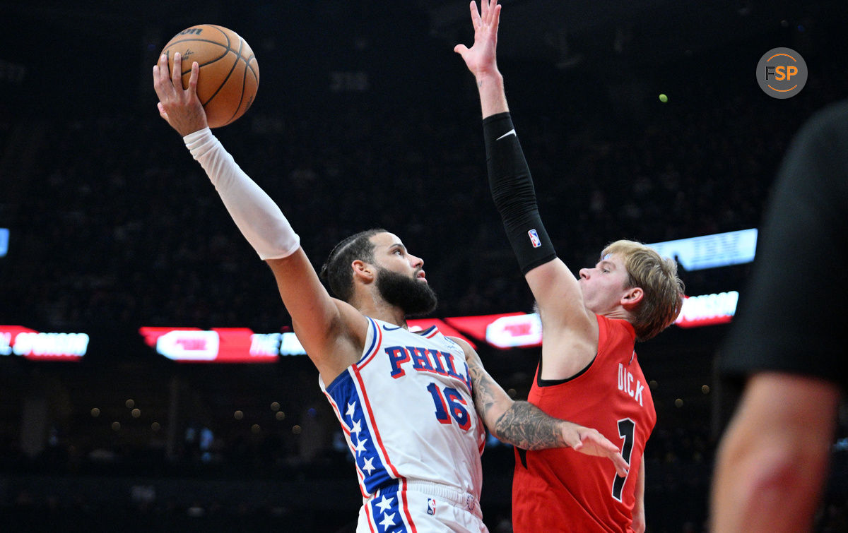 Oct 25, 2024; Toronto, Ontario, CAN;  Philadelphia 76ers forward Caleb Martin (16) shoots the ball as Toronto Raptors forward Gradey Dick (1) defends in the first half at Scotiabank Arena. Credit: Dan Hamilton-Imagn Images