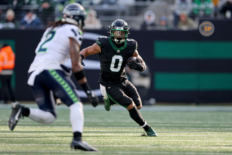 Dec 1, 2024; East Rutherford, New Jersey, USA; New York Jets running back Braelon Allen (0) carries the ball asSeattle Seahawks safety Rayshawn Jenkins (2) defends during the first quarter at MetLife Stadium. Credit: Vincent Carchietta-Imagn Images