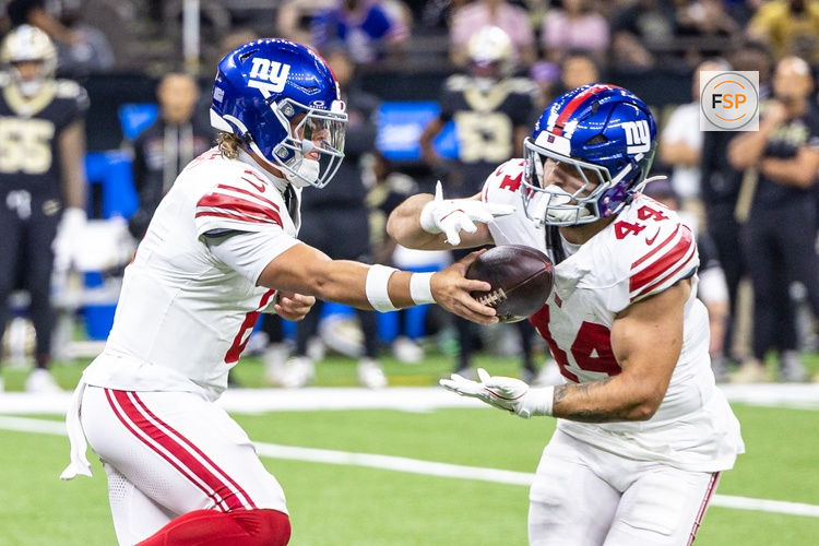Oct 5, 2025; New Orleans, Louisiana, USA;  New York Giants quarterback Jaxson Dart (6) hands off to running back Cam Skattebo (44) during the first half at Caesars Superdome. Credit: Stephen Lew-Imagn Images
