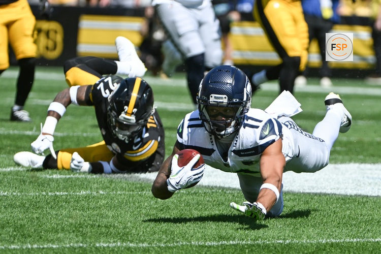 Sep 14, 2025; Pittsburgh, Pennsylvania, USA; Seattle Seahawks wide receiver Jaxon Smith-Njigba (11) is tackled by Pittsburgh Steelers safety Juan Thornhill (22) during the first quarter at Acrisure Stadium. Credit: Barry Reeger-Imagn Images