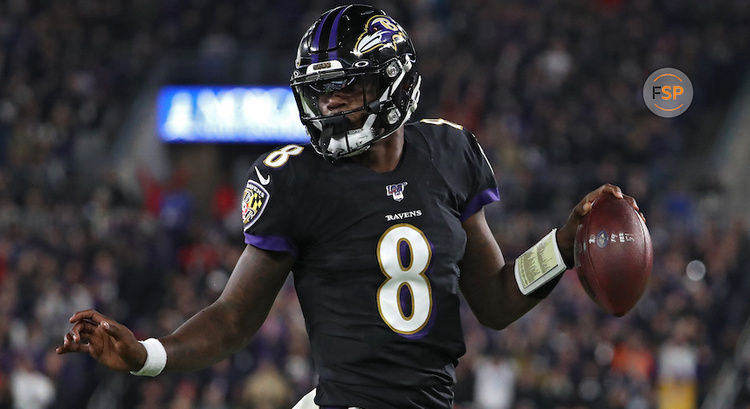 BALTIMORE, MARYLAND - NOVEMBER 03: Quarterback Lamar Jackson #8 of the Baltimore Ravens scores a first quarter touchdown  against the New England Patriots at M&T Bank Stadium on November 3, 2019 in Baltimore, Maryland. (Photo by Todd Olszewski/Getty Images)