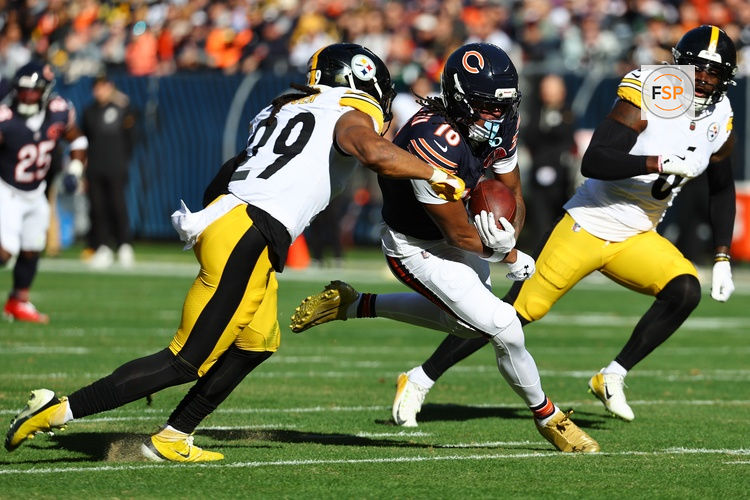Nov 23, 2025; Chicago, Illinois, USA; Chicago Bears wide receiver Luther Burden III (10) makes a catch agsiasnt Pittsburgh Steelers safety Kyle Dugger (29) during the first half at Soldier Field. Credit: Mike Dinovo-Imagn Images
