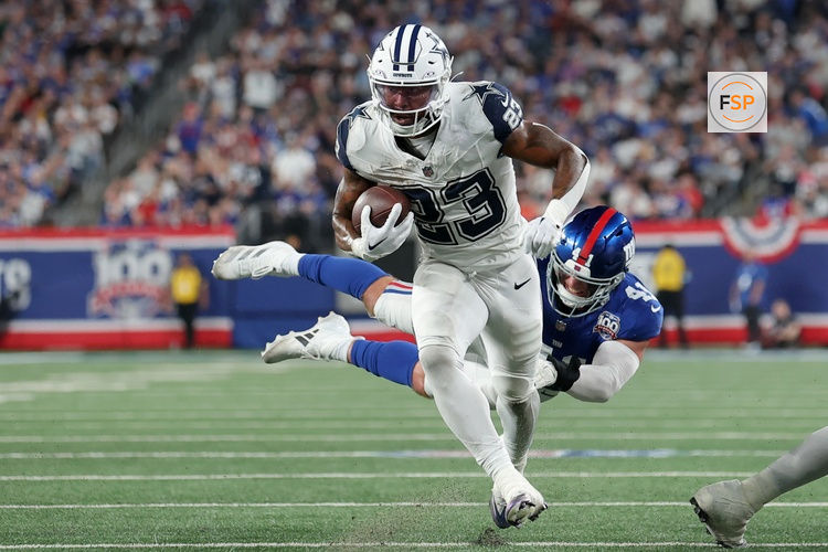 Sep 26, 2024; East Rutherford, New Jersey, USA; Dallas Cowboys running back Rico Dowdle (23) runs for a touchdown against New York Giants linebacker Micah McFadden (41) during the first quarter at MetLife Stadium. Credit: Brad Penner-Imagn Images