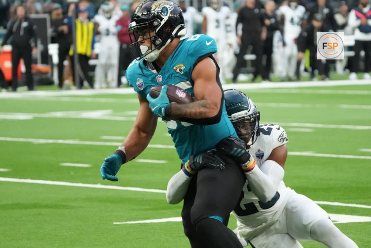 Oct 11, 2026; Tottenham, ENG;  Jacksonville Jaguars tight end Brenton Strange (85) is tackled by Philadelphia Eagles cornerback Mac McWilliams (22) during the second half at Tottenham Hotspur Stadium.  Credit: Kirby Lee-Imagn Images