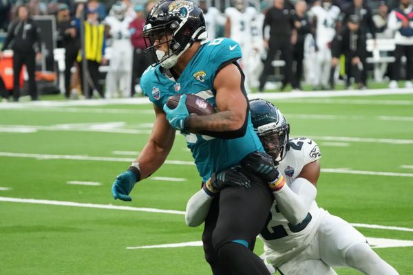 Oct 11, 2026; Tottenham, ENG;  Jacksonville Jaguars tight end Brenton Strange (85) is tackled by Philadelphia Eagles cornerback Mac McWilliams (22) during the second half at Tottenham Hotspur Stadium.  Mandatory Credit: Kirby Lee-Imagn Images