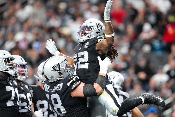 Dec 22, 2024; Paradise, Nevada, USA; Las Vegas Raiders running back Alexander Mattison (22) celebrates with Las Vegas Raiders guard Jackson Powers-Johnson (58) after scoring a touchdown against the Jacksonville Jaguars during the second quarter at Allegiant Stadium. Mandatory Credit: Stephen R. Sylvanie-Imagn Images