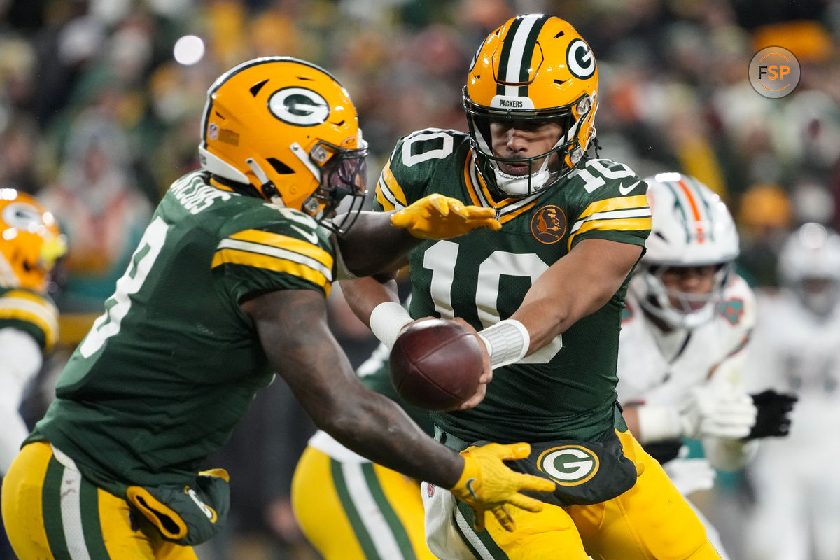 Nov 28, 2024; Green Bay, Wisconsin, USA;  Green Bay Packers quarterback Jordan Love (10) hands the football off to running back Josh Jacobs (8) during the fourth quarter against the Miami Dolphins at Lambeau Field. Credit: Jeff Hanisch-Imagn Images