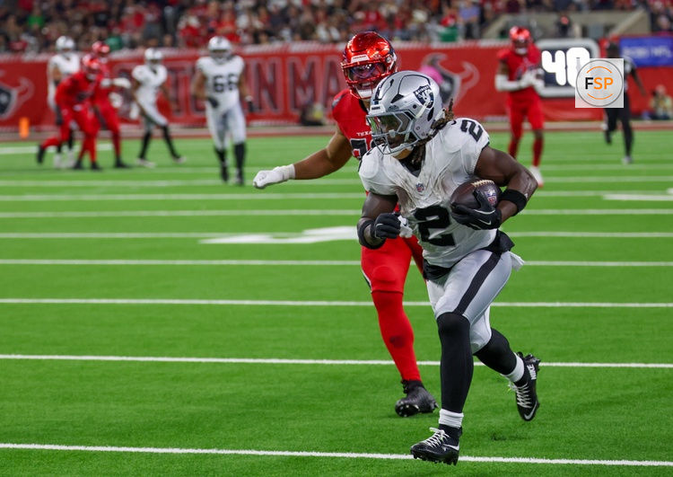 Dec 21, 2025; Houston, Texas, USA; Las Vegas Raiders running back Ashton Jeanty (2) catches a touchdown pass against Houston Texans linebacker Henry To'Oto'O (39) in the second half at NRG Stadium. Credit: Thomas Shea-Imagn Images