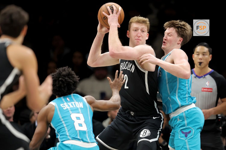 Dec 1, 2025; Brooklyn, New York, USA; Brooklyn Nets forward Danny Wolf (2) looks to pass the ball against Charlotte Hornets guards Kon Knueppel (7) and Collin Sexton (8) during the first quarter at Barclays Center. Credit: Brad Penner-Imagn Images