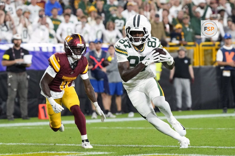 Sep 11, 2025; Green Bay, Wisconsin, USA; Green Bay Packers wide receiver Romeo Doubs (87) scores a touchdown against Washington Commanders cornerback Mike Sainristil (0) in the first quarter at Lambeau Field. Credit: Jeff Hanisch-Imagn Images