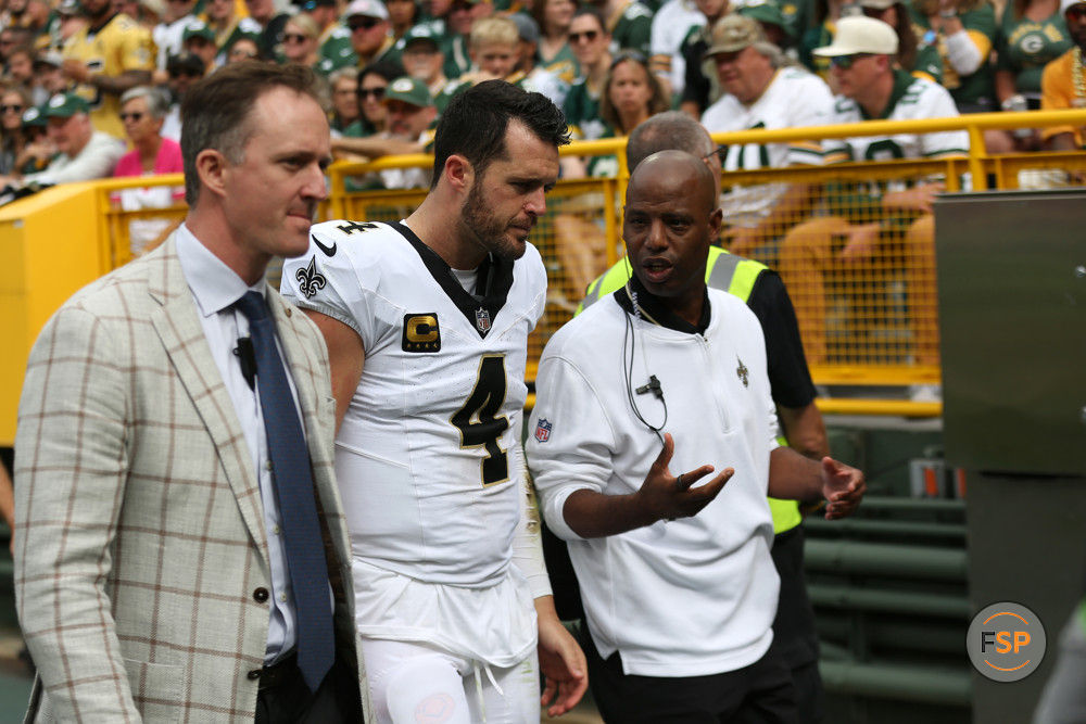 GREEN BAY, WI - SEPTEMBER 24: New Orleans Saints quarterback Derek Carr (4) is led off the field during a game between the Green Bay Packers and the New Orleans Saints on September 24, 2023 at Lambeau Field in Green Bay, WI. (Photo by Larry Radloff/Icon Sportswire)