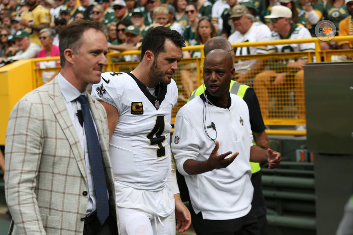 GREEN BAY, WI - SEPTEMBER 24: New Orleans Saints quarterback Derek Carr (4) is led off the field during a game between the Green Bay Packers and the New Orleans Saints on September 24, 2023 at Lambeau Field in Green Bay, WI. (Photo by Larry Radloff/Icon Sportswire)