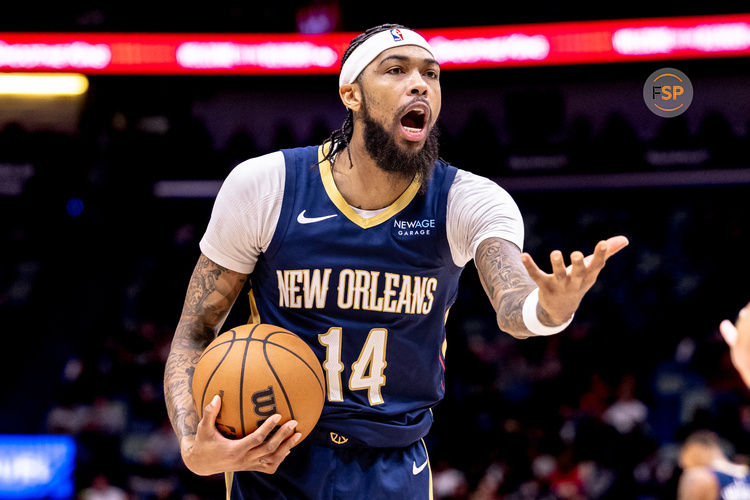 Dec 5, 2024; New Orleans, Louisiana, USA;  New Orleans Pelicans forward Brandon Ingram (14) reacts to a play against Phoenix Suns guard Devin Booker (1) during the first half  at Smoothie King Center. Credit: Stephen Lew-Imagn Images