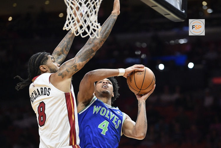 Oct 10, 2026; Miami, Florida, USA;  Minnesota Timberwolves shooting guard Terrence Shannon Jr. (4) scores over Miami Heat center Nick Richards (8) during the first half at Kaseya Center.  Credit: Michael Laughlin-Imagn Images
