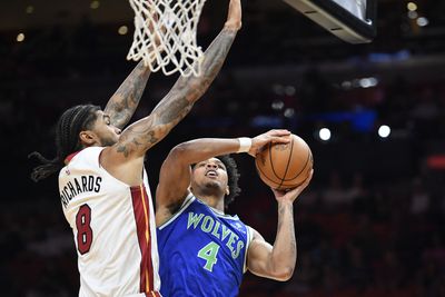 Oct 10, 2026; Miami, Florida, USA;  Minnesota Timberwolves shooting guard Terrence Shannon Jr. (4) scores over Miami Heat center Nick Richards (8) during the first half at Kaseya Center.  Mandatory Credit: Michael Laughlin-Imagn Images
