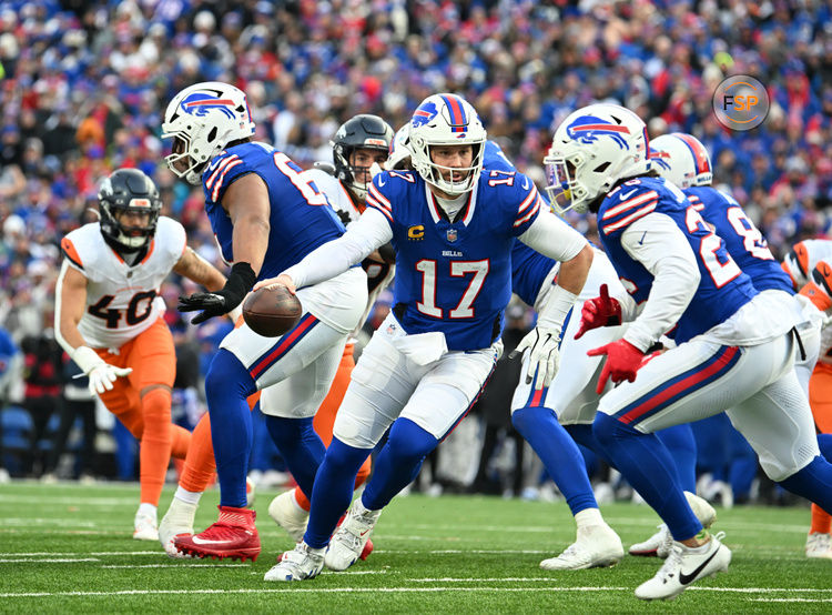 Jan 12, 2025; Orchard Park, New York, USA; Buffalo Bills quarterback Josh Allen (17) hands the ball off to running back Ty Johnson (26) during the fourth quarter against the Denver Broncos in an AFC wild card game at Highmark Stadium. Credit: Mark Konezny-Imagn Images