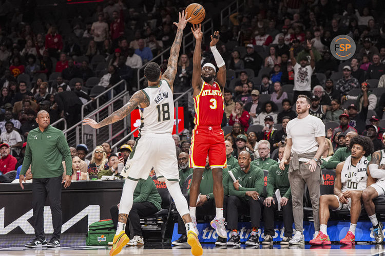 Mar 4, 2025; Atlanta, Georgia, USA; Atlanta Hawks guard Caris LeVert (3) shoots over Milwaukee Bucks forward Kyle Kuzma (18) during the second half at State Farm Arena. Credit: Dale Zanine-Imagn Images